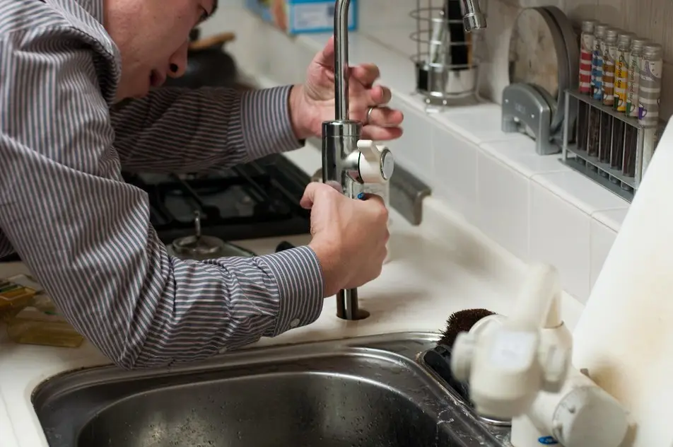 Licensed plumber working on a residential repair
